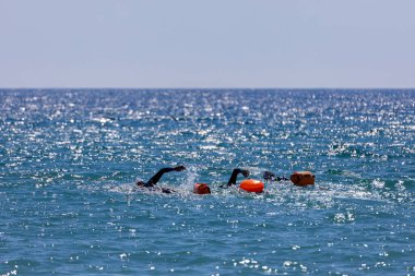 Swimmers training on the open sea / ocean.