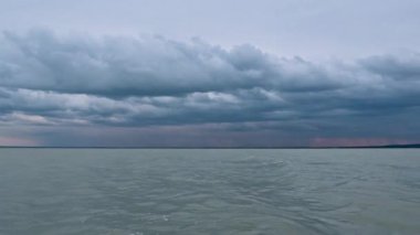 Günbatımında Macaristan 'daki Balaton gölünde küçük dalgalar