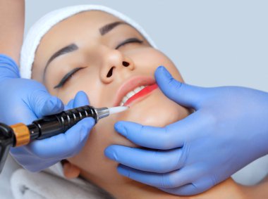 Kalıcı makyaj Güzellik Salonu içinde güzel kadın kırmızı dudaklar için. Tatlı Şevval Özçelik Güzellik dudak dövme yapıyor.