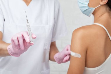 Genç bir kadın hastanede koronavirüs aşısı oluyor. Sağlıklı yaşam tarzı kavramı.