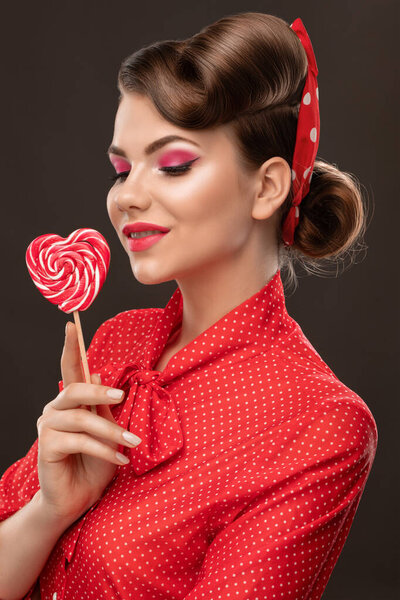 Young beautiful woman with a beautiful hairstyle and bright makeup. Professional makeup and facial care.