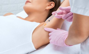 Doktor koltukaltı bölgesinde hiperhidrosite karşı botulinyum toksini enjekte ediyor. Kadın kozmetolojisi kavramı.