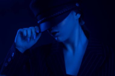 Bereli ve takım elbiseli zarif bir kızın portresi. Fotoğraf neon biçiminde.