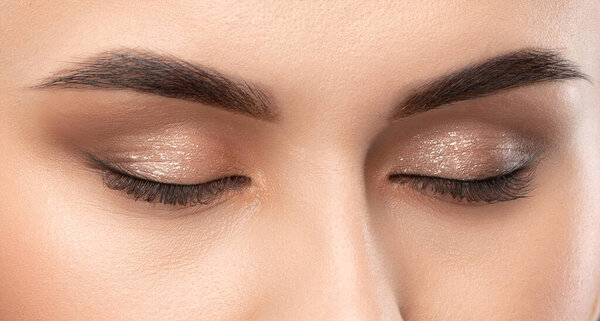 Portrait of a beautiful brunette girl with beautiful makeup and healthy clean skin.Professional makeup concept