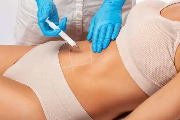 stock image Lipolytic injections for burning fat on the abdomen, legs and thighs of a woman. Women's aesthetic cosmetology in a beauty salon.