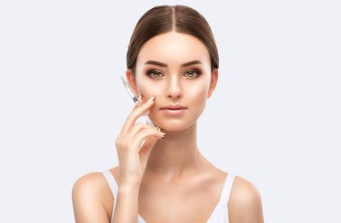 Cosmetologist does injections for lips augmentation and anti wrinkle injections of a beautiful woman. Women's cosmetology in the beauty salon. clipart