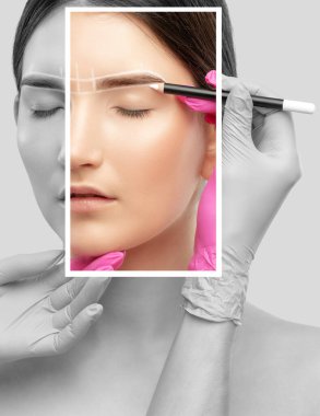 Makyaj sanatçısı kaşlar için beyaz kalemle işaretler yapar ve kaşları boyar. Profesyonel makyaj ve yüz bakımı.