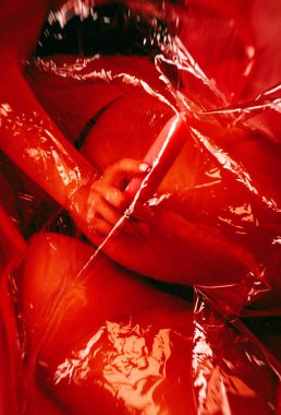 Beyaz bir yatakta seksi iç çamaşırlı zayıf bir kadın. Şeffaf polietilen kapağı var..