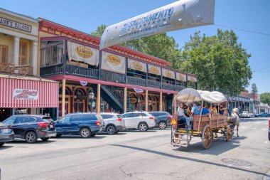 Sacramento, CA - May 25, 2023: Historic buildings line the street in Old Town Sacramento located near the waterfront of the city of Sacramento, California. clipart