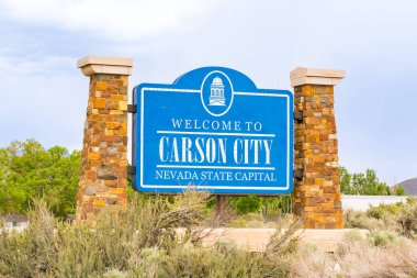 Carson City, NE - May 24, 2023: Welcome to Carson City the Nevada State Capital sign along the Road clipart