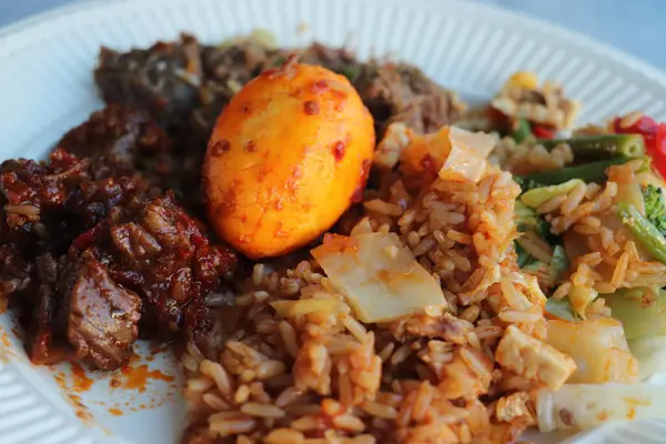 Nasi Rames, Indonesian take away meal: spicy meat, vegetables, egg and rice.
