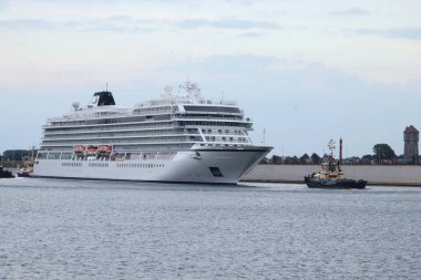Velsen, the Netherlands - September 30th 2022: MV Mars operated by Viking Cruises, leaving Zeesluis Ijmuiden, biggest sea lock in the world. clipart