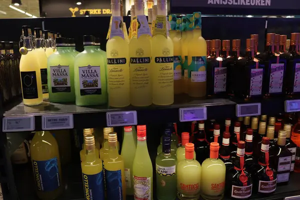 stock image Beverwijk, the Netherlands - June 8th 2024: Various brands of Limoncello in bottles. Tags: price and product information in Dutch