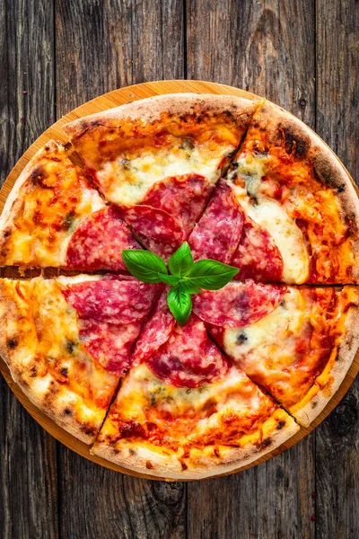 Circle pepperoni pizza with mozzarella cheese on wooden table