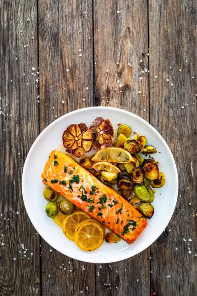 Fried Salmon Steak Garlic Brussels Sprouts Lemon Served Wooden Table — Stock Photo, Image
