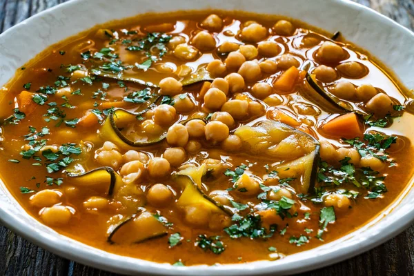 Stock image Fresh vegetable soup with chickpeas, zucchini and sweet potatoes on wooden table 