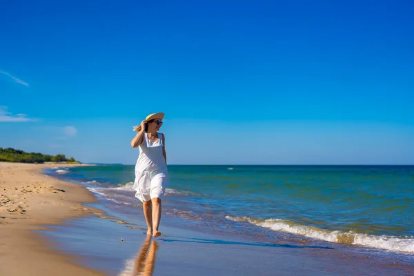 stock image Beautiful mid adult woman walking on sunny beach