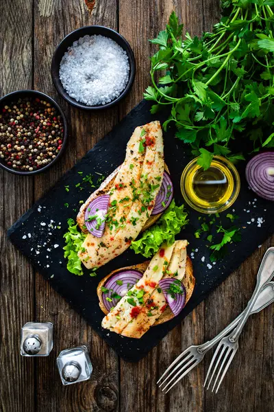 Tasty Sandwiches Toasted Bread Pickled Herrings Red Onion Wooden Table — Stock Photo, Image