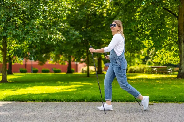 Nordic Walking Frau Trainiert Stadtpark lizenzfreie Stockfotos