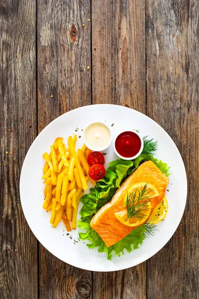 Fried Salmon Steak French Fries Fresh Vegetable Salad Served Wooden Stock Picture
