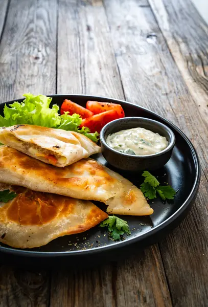stock image Cheburek - deep-fried turnovers filled with ground meat and vegetables on wooden table 