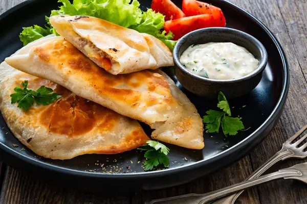 stock image Cheburek - deep-fried turnovers filled with ground meat and vegetables on wooden table 