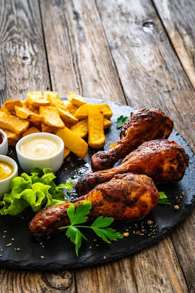 Roast Chicken Drumsticks French Fries Wooden Table รูปภาพสต็อก