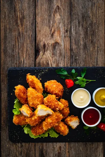 Fried Breaded Chicken Nuggets Served Mayonnaise Ketchup Mustard Wooden Table stockbilde