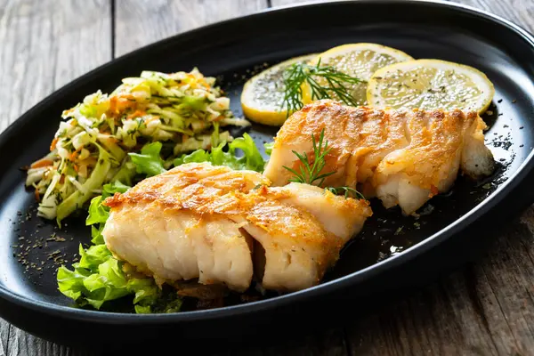 Fried Codfish Loin Served Cabbage Salad Lemon Slices Black Plate Stock Image