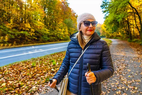 Autumnal Nordic Walking Mid Adult Beautiful Woman Exercising City Park Stok Lukisan  