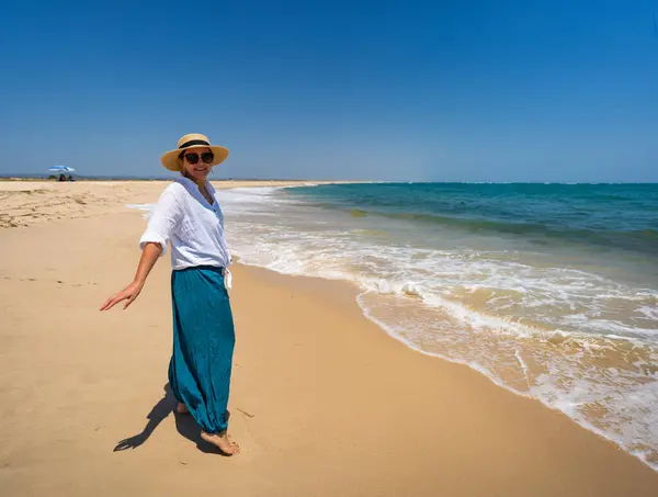 stock image Beautiful woman walking on sunny beach Portugal, Algarve, Armona beach