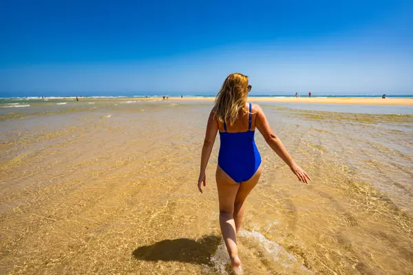 stock image Beautiful woman walking on sunny beach Portugal, Algarve, Armona beach 