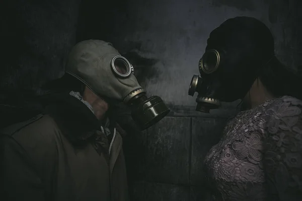 Two People Gas Masks Stand Wall Small Dark Room Look — Stock Photo, Image