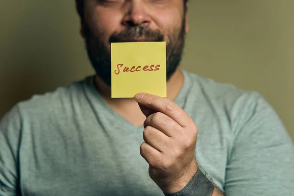 Bearded European Man Holds Blue Sticker Front Him Word Success Royalty Free Stock Photos