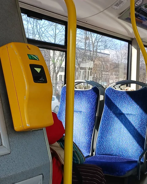 validates ticket in a public transport during transportation,