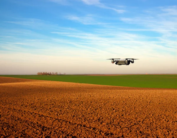 The drone is flying over the plowed field agriculture industry