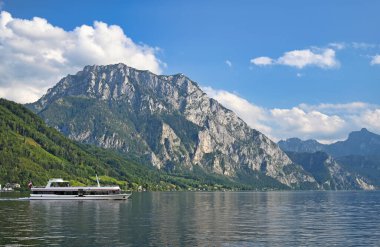 Ferry boat sails on Lake Traun Traunsee in Upper Austria  clipart