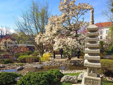 Old stone pagoda Setagaya Park in springtime Vienna Austria clipart