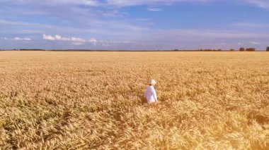Buğday tarlasında vakit geçiren bir kadın.