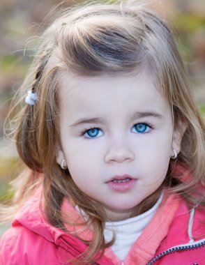 Mavi gözlü küçük kızın yakın plan portresi.