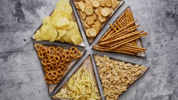 Mix Snacks Served Small Triangle Plates Pretzels Crackers Chips Nuts — Stock Video