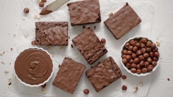 Delicious Homemade Chocolate Brownie Served Hazelnuts Melted Cream Baking Paper — Vídeo de stock
