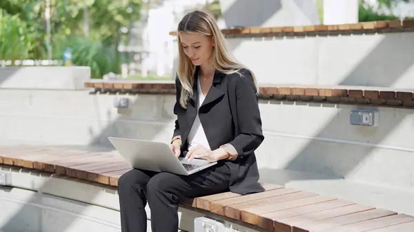 Focused Businesswoman Works Intently Her Laptop While Seated Outdoor Bench Stock Photo