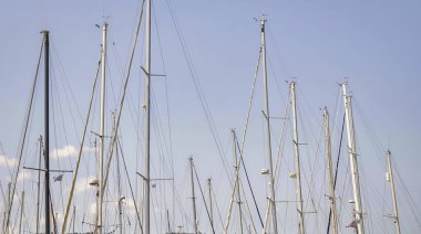 Bulutsuz gökyüzüne karşı boş yelkenli direkleri