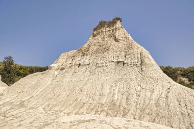 natural landscape formed by rainwater erosion depicting the earth pyramids at Komolithi in Crete clipart