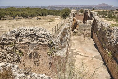 Landscape with ruins of Ancient Roman L shaped cisterns in Aptera on the island of Crete in Greece clipart