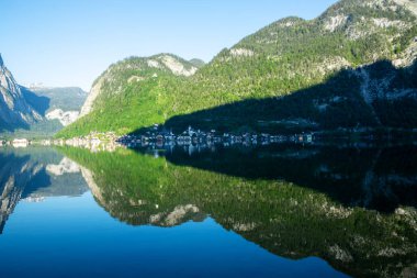 Hallstatt reflected in morning in the lake , Austria