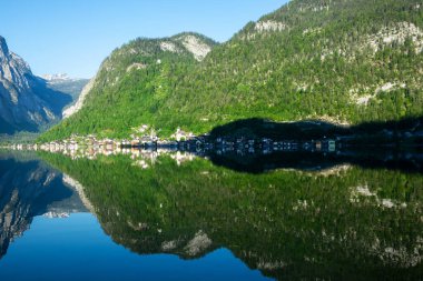 Hallstatt reflected in morning in the lake , Austria