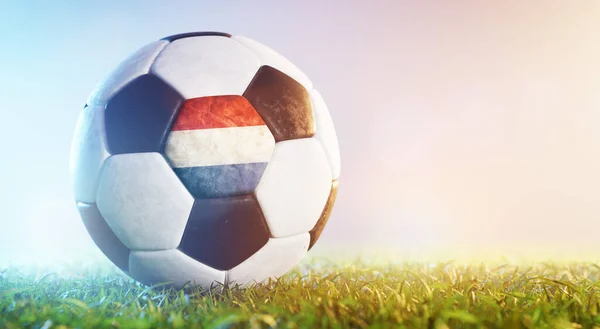 Football soccer ball with flag of the Netherlands on grass. Dutch national team