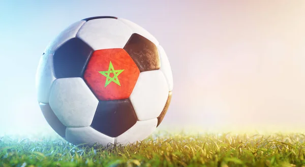 Football soccer ball with flag of Marocco grass. Maroccan national team